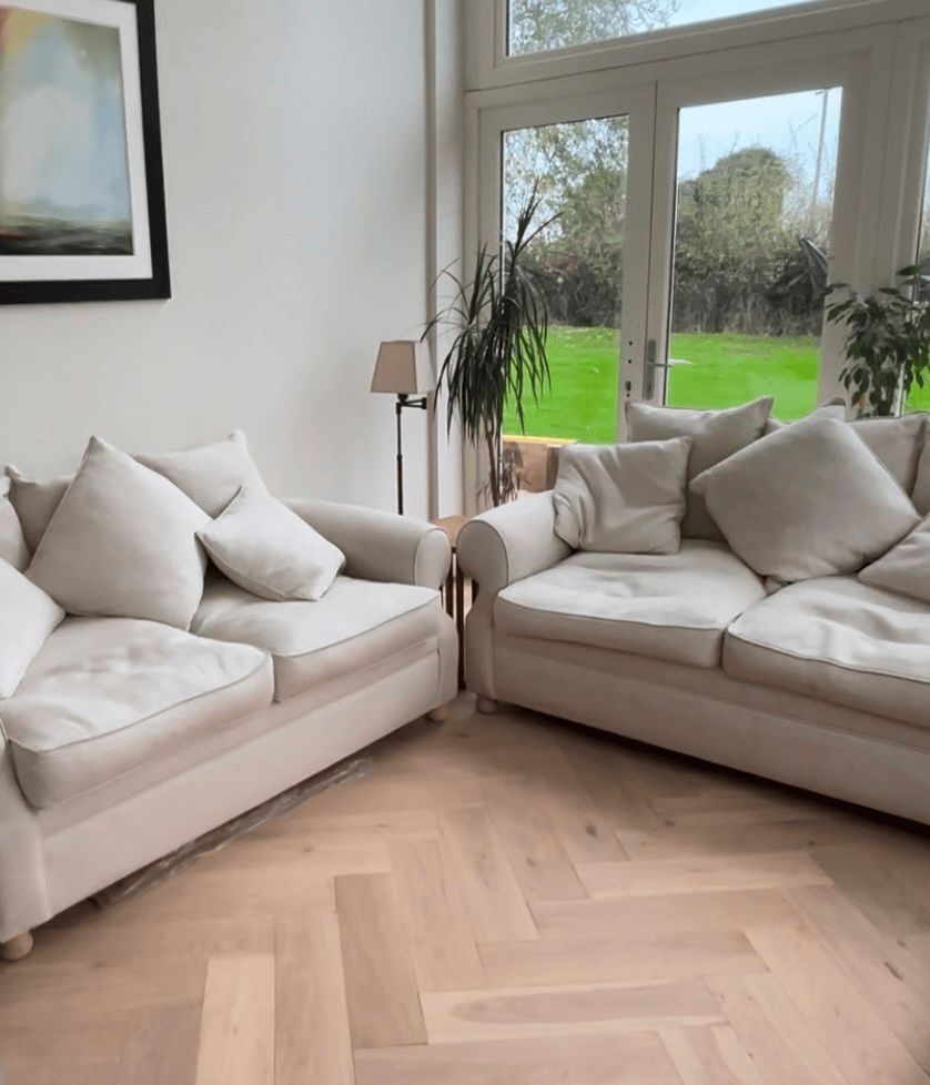 Engineered wood herringbone light oak hardwood flooring installation in Nottingham with cream comfy sofas.