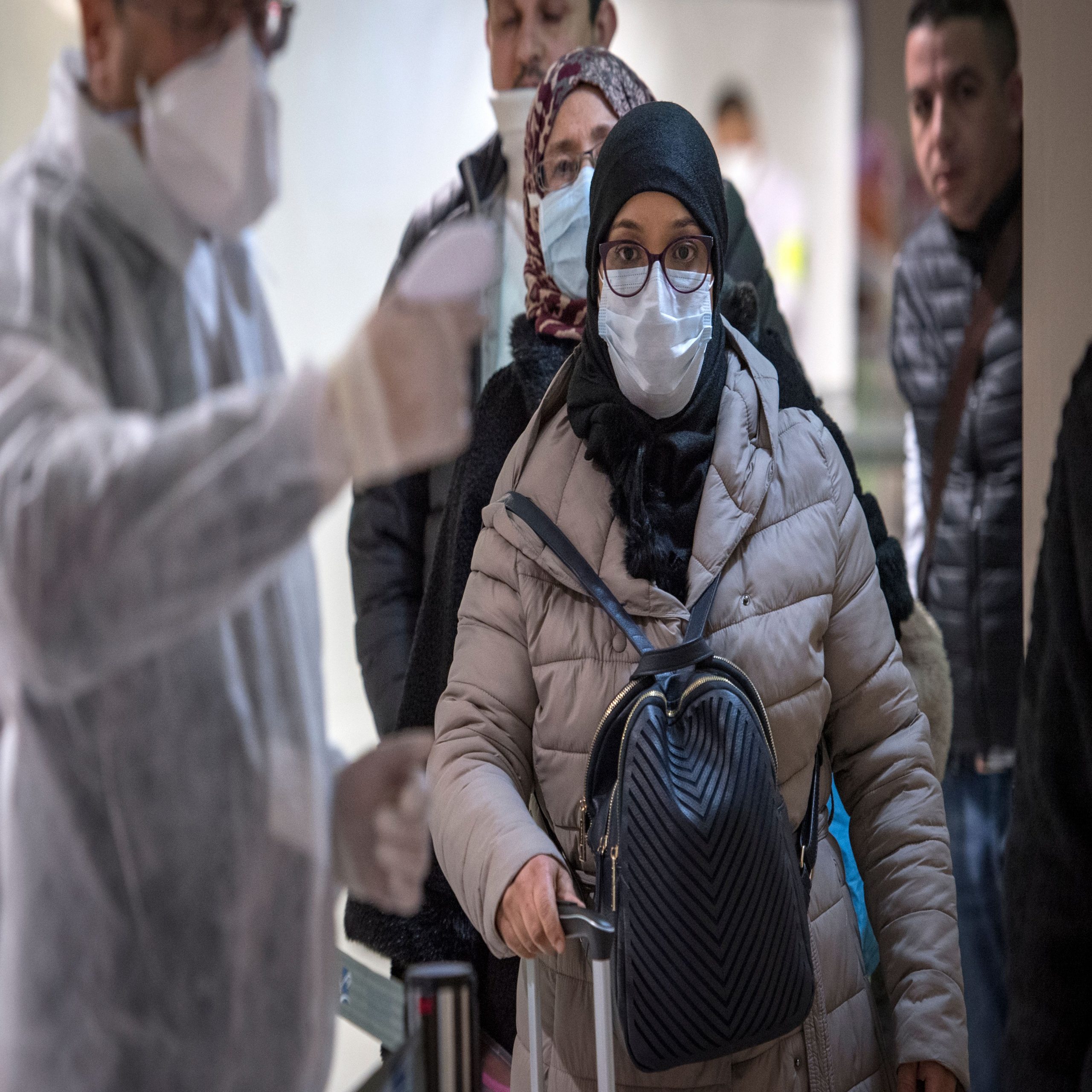 Moroccan health workers scan passengers arriving from Italy for coronavirus COVID-19 at Casablanca Mohammed V International Airport on March 3, 2020. (Photo by FADEL SENNA / AFP) (Photo by FADEL SENNA/AFP via Getty Images)