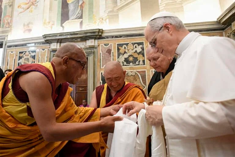 Pope Leo XIV greets Buddhist monks who present him with gifts during a meeting with religious leaders at the Vatican May 19, 2025. The leaders were in Rome for the pope’s inauguration Mass. (CNS photo/Vatican Media)