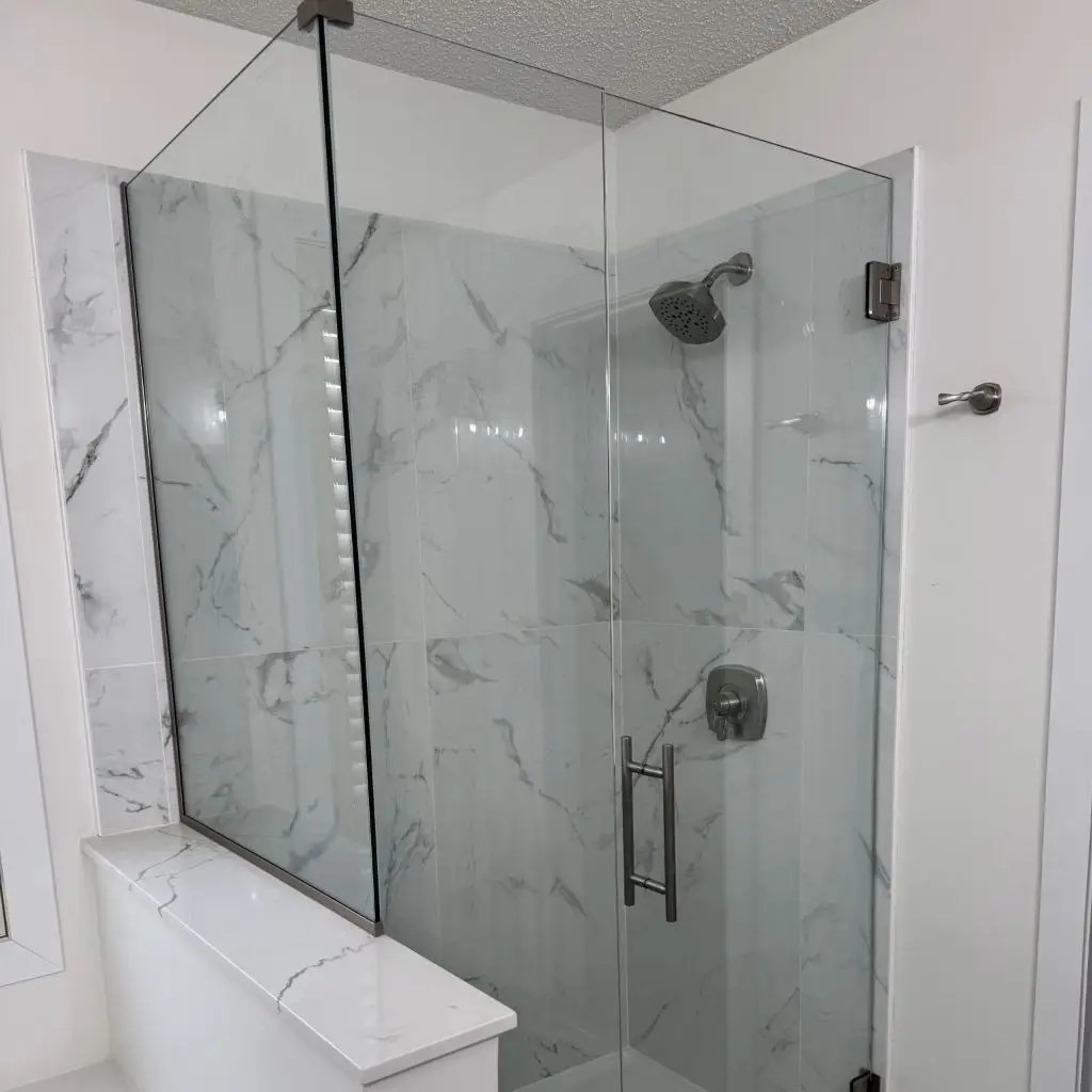 A walk in shower with marble walls and glass