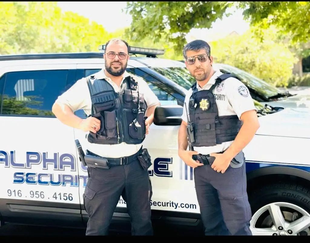 Professional security guards standing beside a patrol vehicle for business security in Queen Anne Seattle