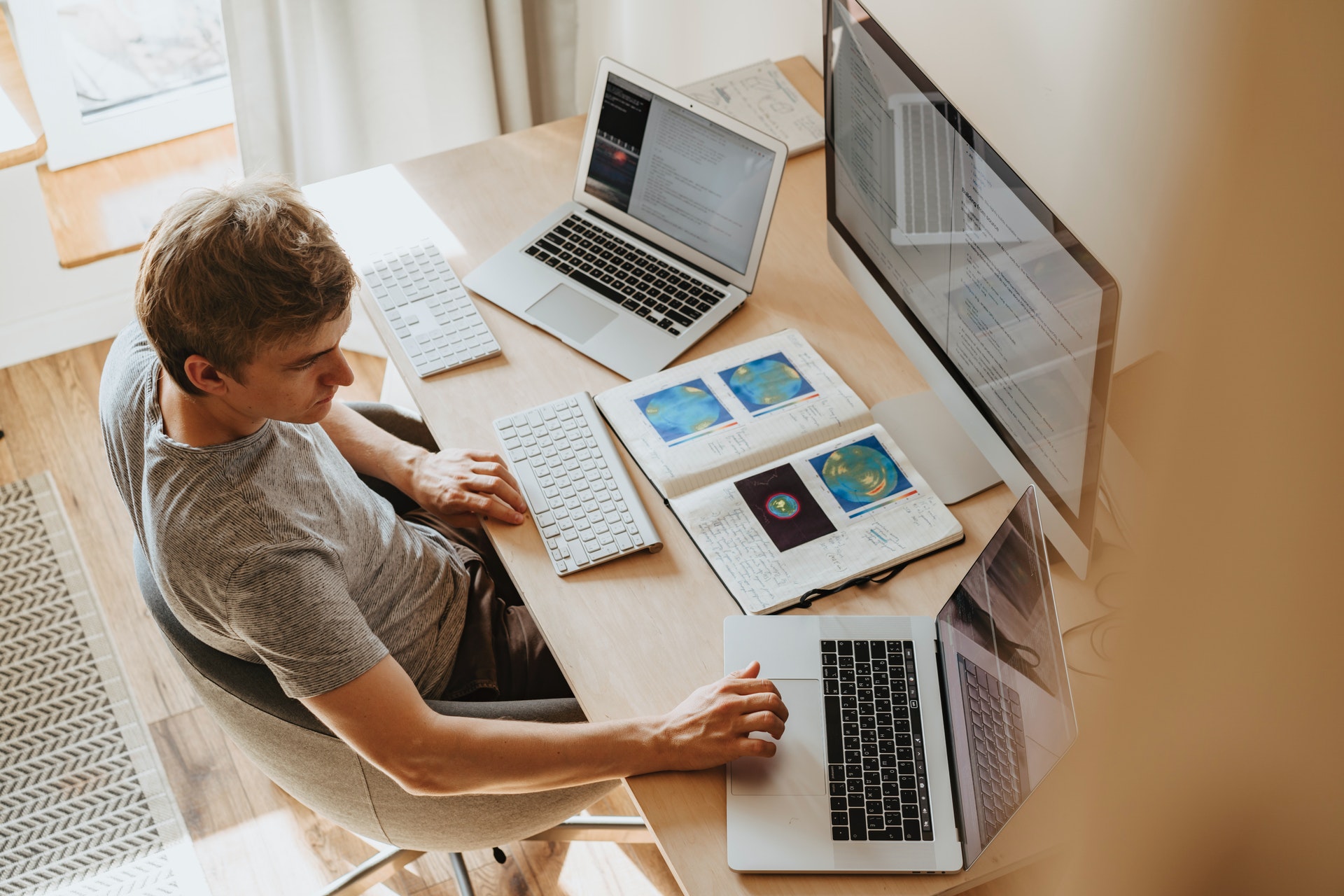 Image of a man working with multiple computers