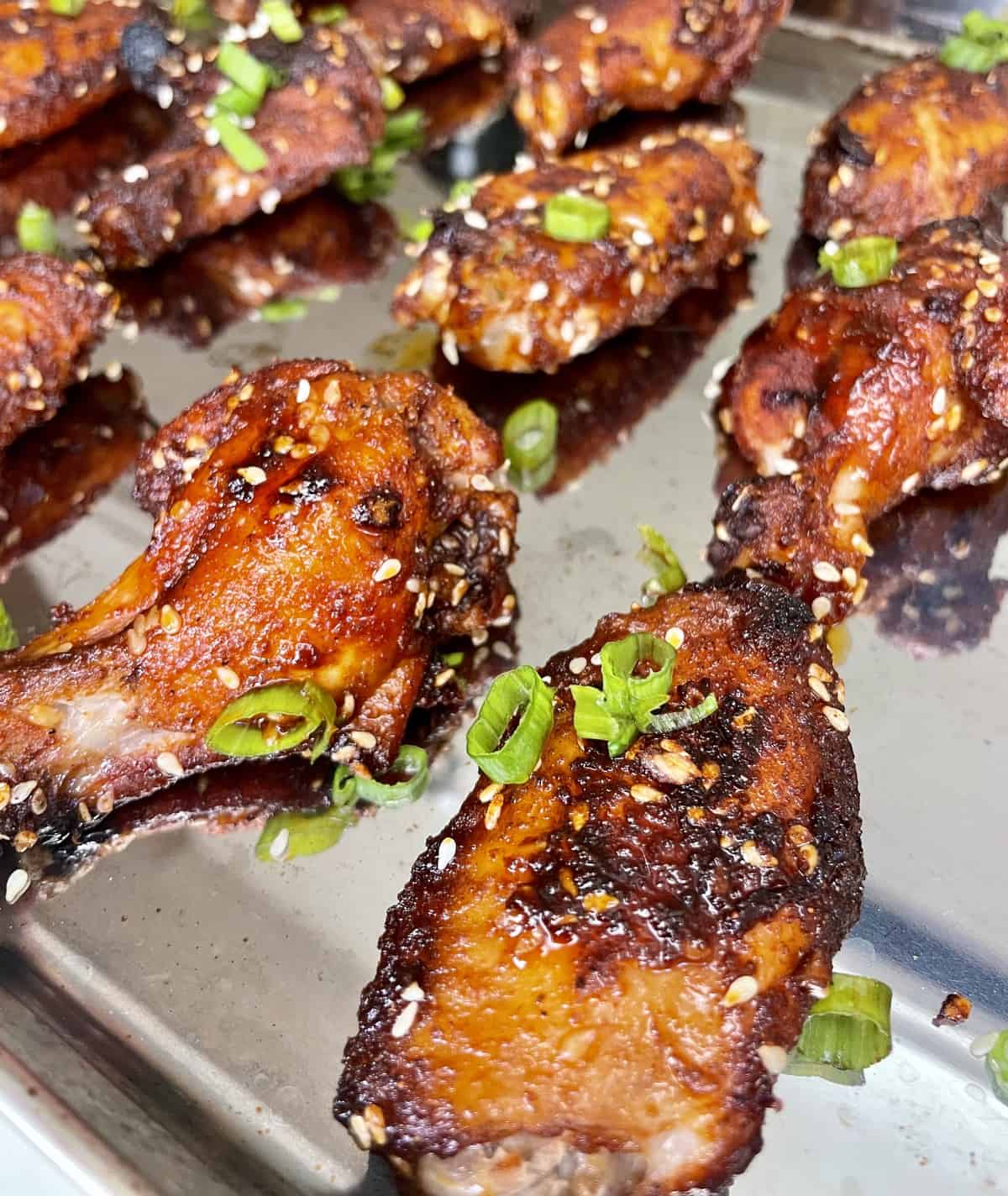 sweet and smoky asian wings on a baking tray