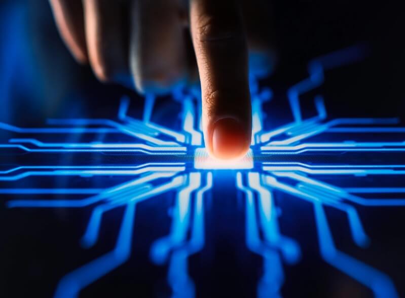 Finger tapping an illuminated AI chip, depicting advanced AC-DC power conversion for high performance in AI computing