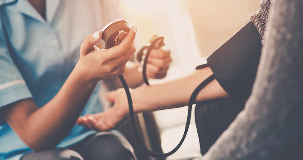 Nurse or doctor checking the blood pressure of a patient