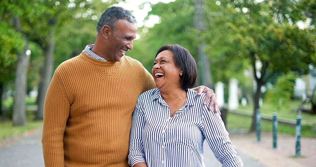 Smiling senior couple on walk outside