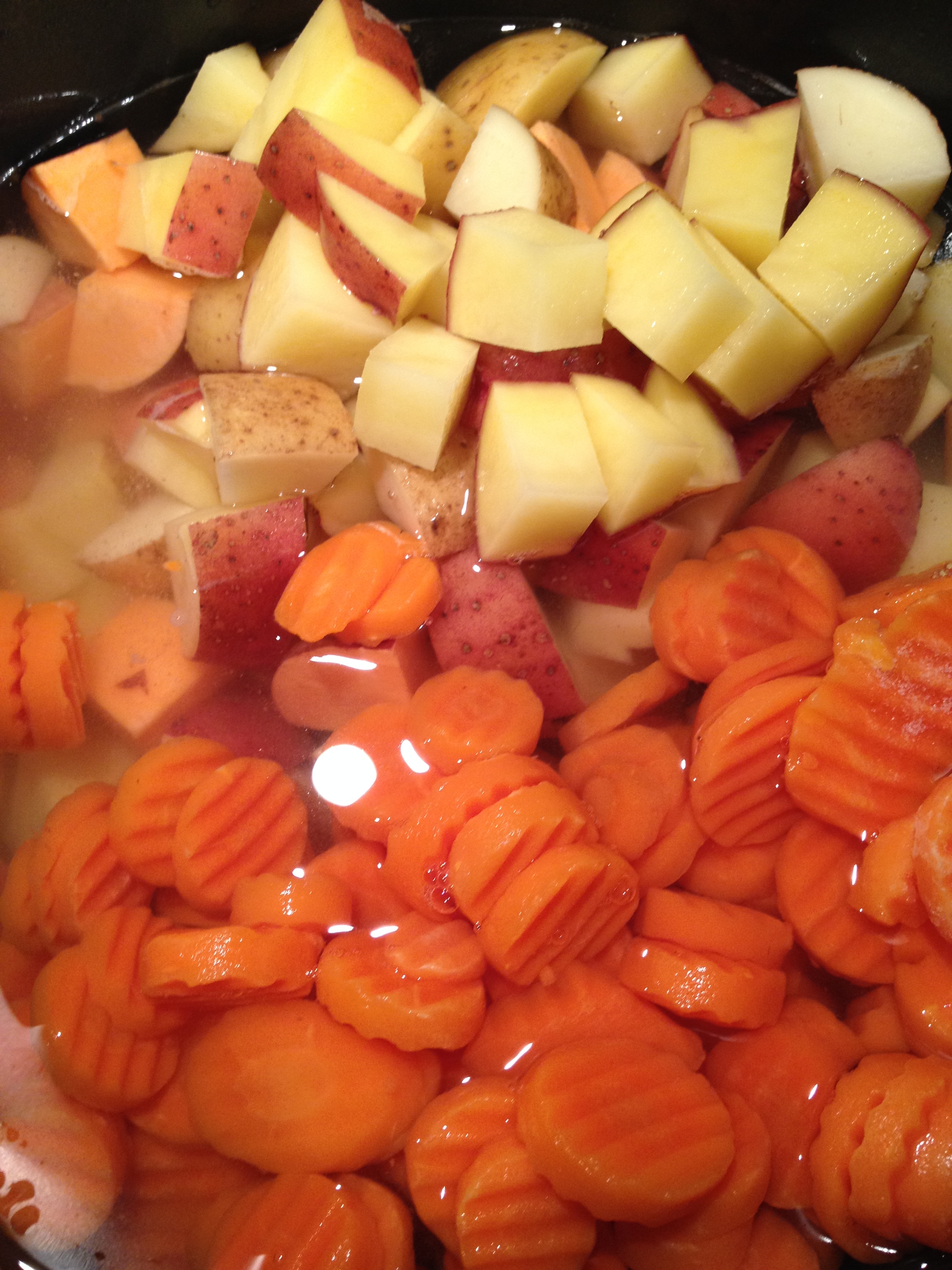 Add potatoes, water and frozen carrots to a stock pot.