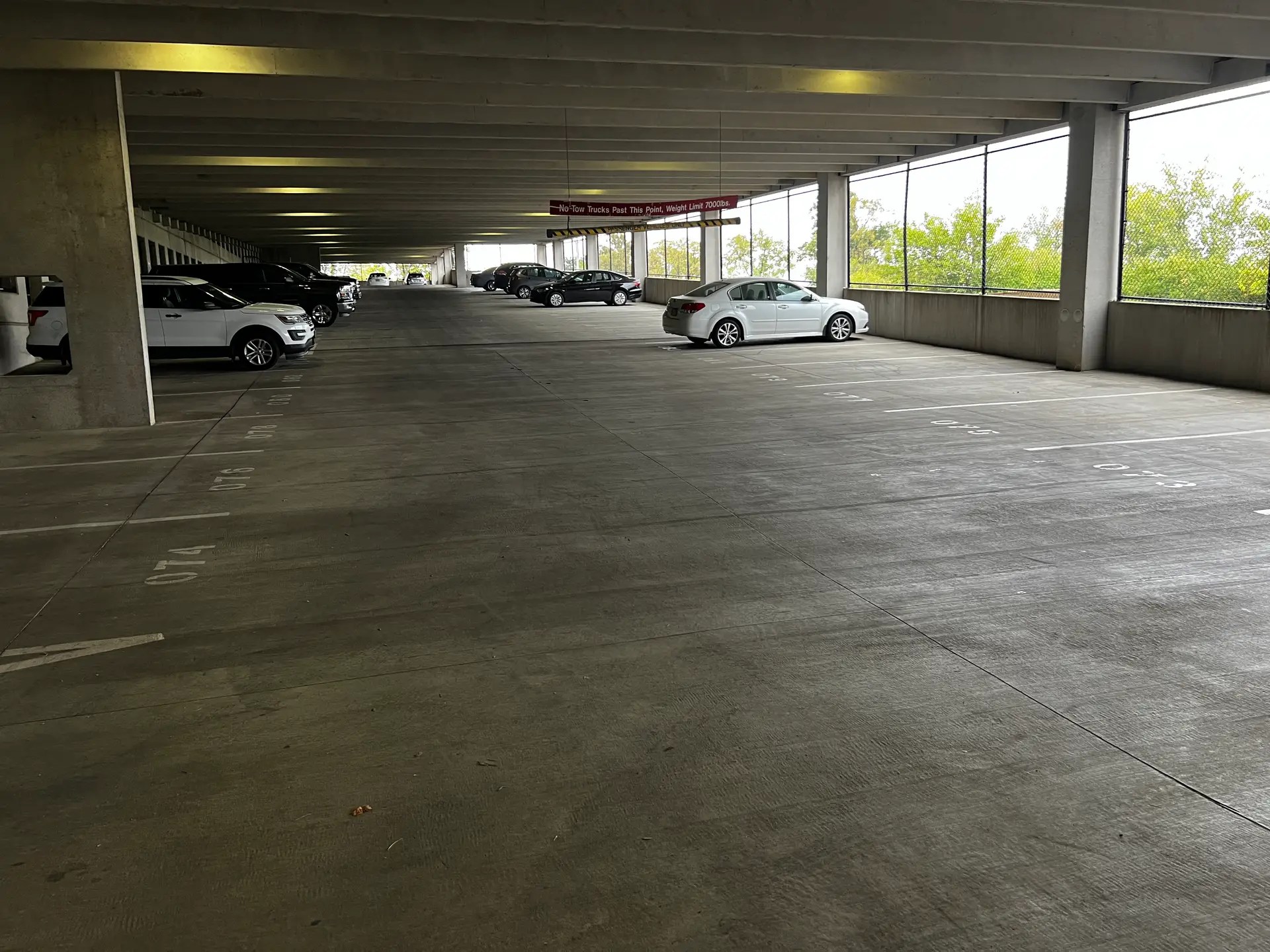 Empty parking garage with few cars