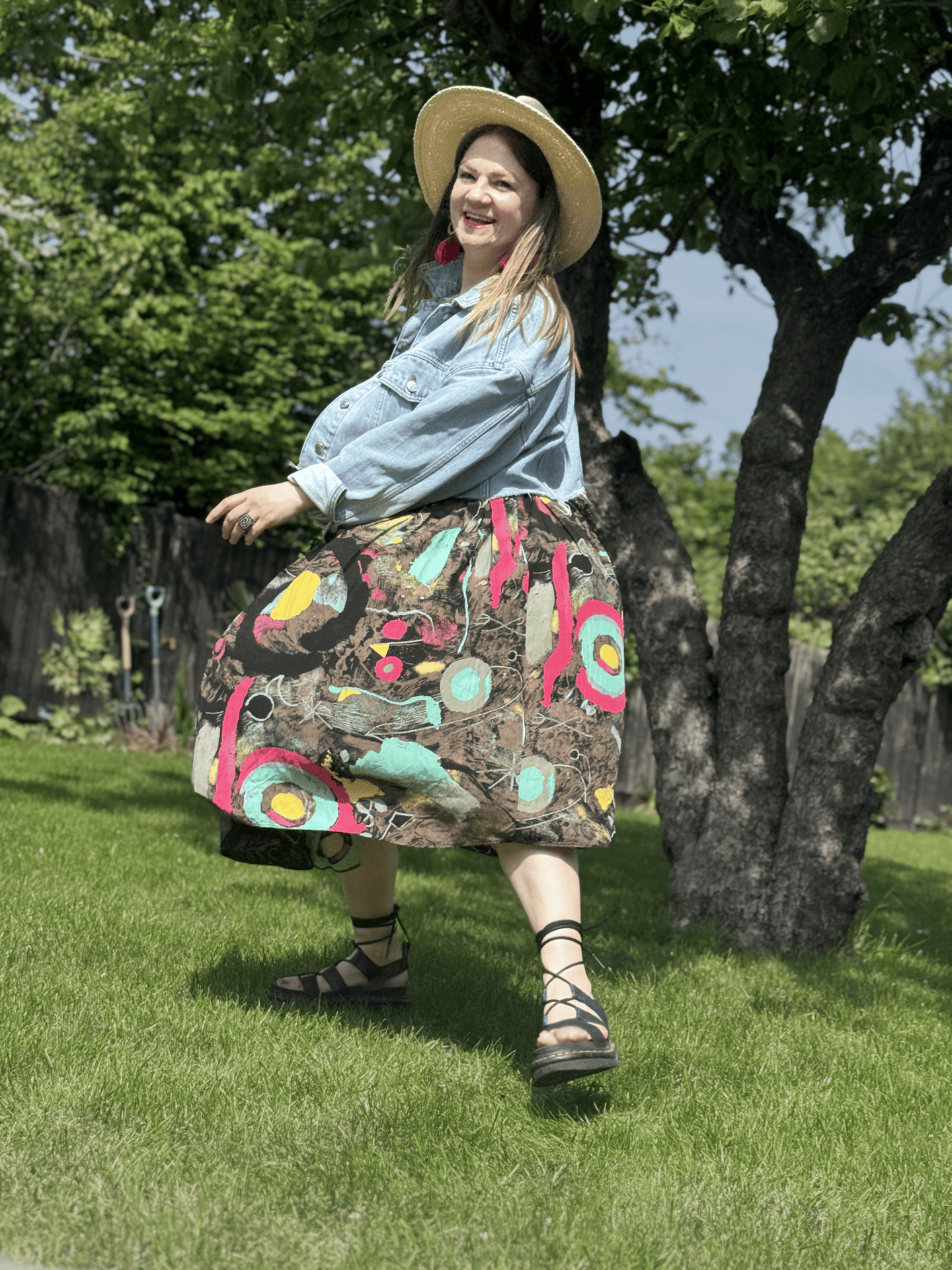 Portrait photograph of artist in garden with tree