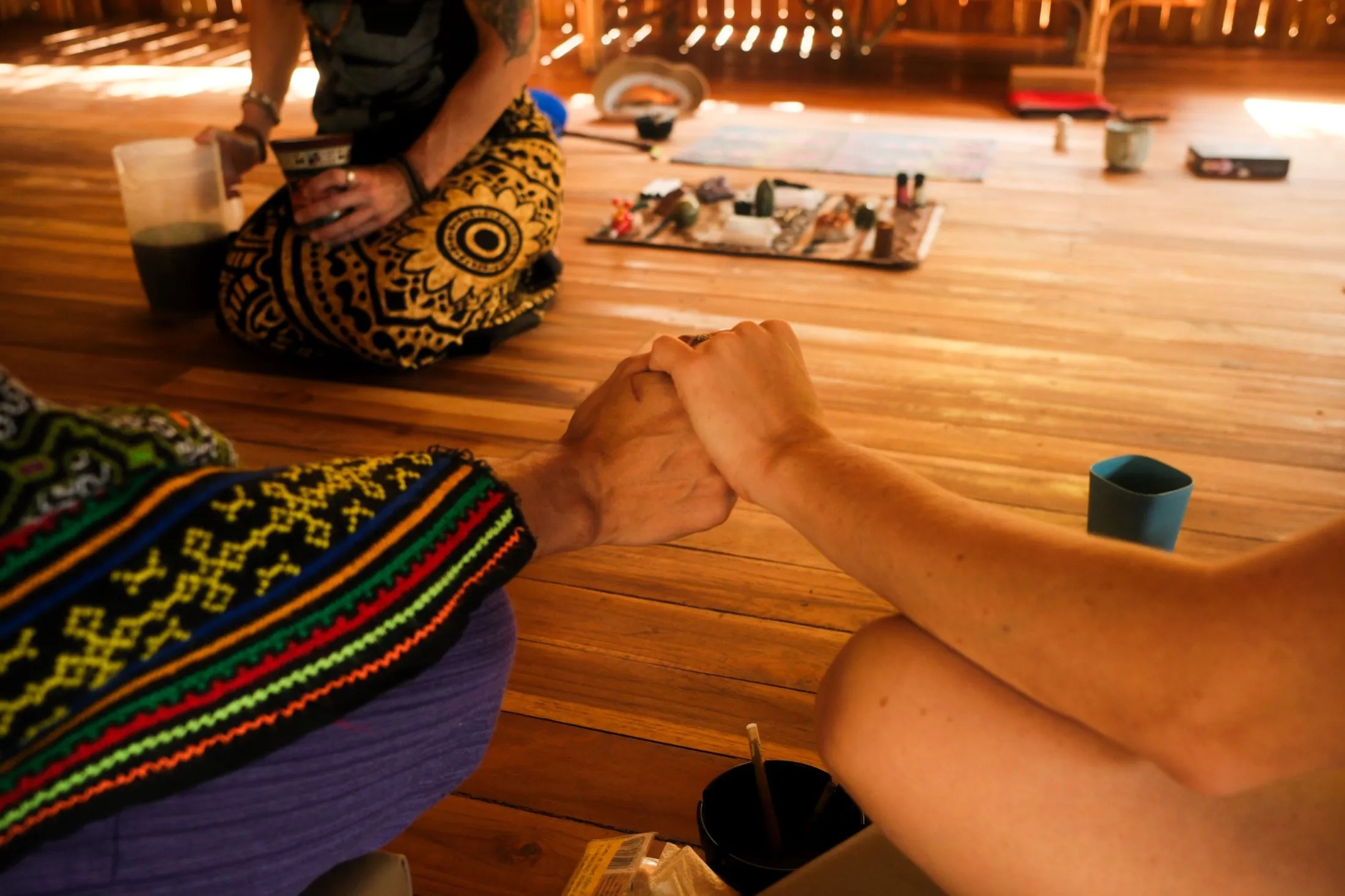 Two people holding hands feeling connection, intention, and shared purpose while preparing to host a retreat