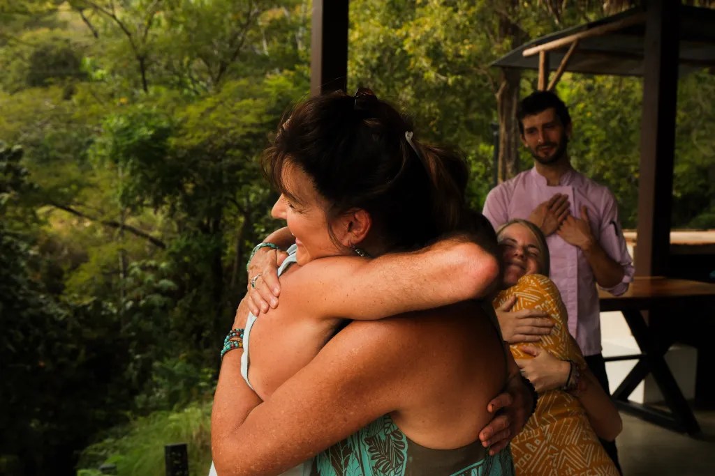 Two people hugging after a powerful experience, celebrating emotional support and community at a hosted retreat