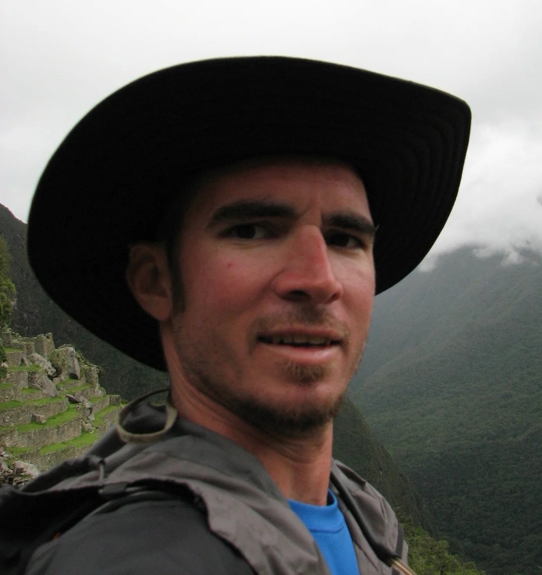Man standing in the Andes before a Peruvian ayahuasca retreat, pausing before a transformative ayahuasca experience story unfolds
