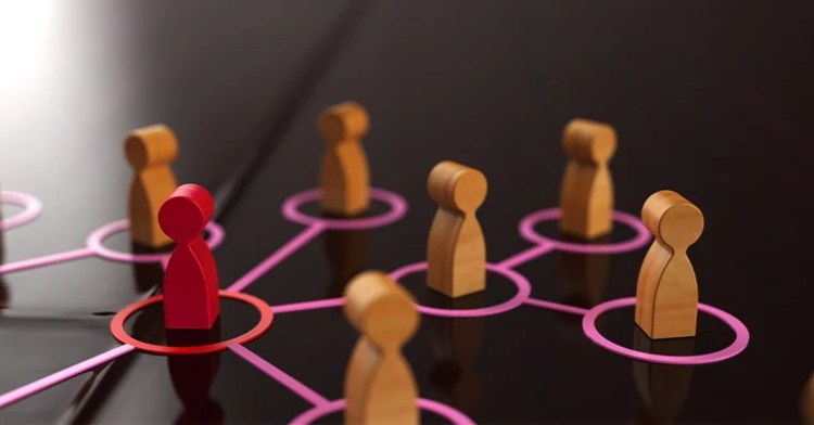 InfluenceMkting_4 • Andrew Roche Wooden figures connected by pink lines, with one red figure standing out among others.