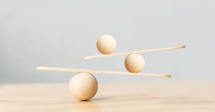 OnlineID_4 • Andrew Roche Wooden spheres and planks carefully balanced to create a minimalist structure symbolizing harmony and stability.