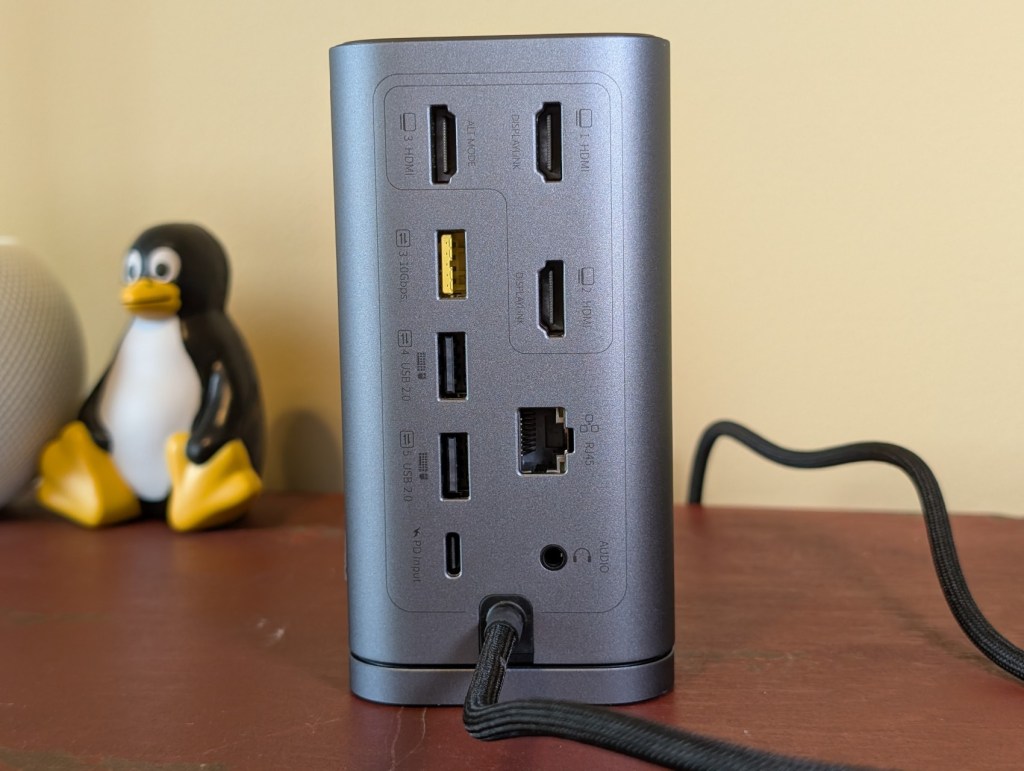 Back view of a Baseus docking station showing multiple ports including HDMI, USB, and Ethernet connections.