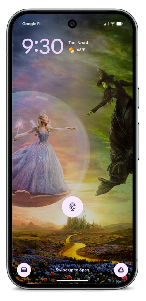 A smartphone displaying a whimsical wallpaper inspired by the Broadway musical 'Wicked', featuring a fairy character and a witch against a colorful, fantastical landscape.