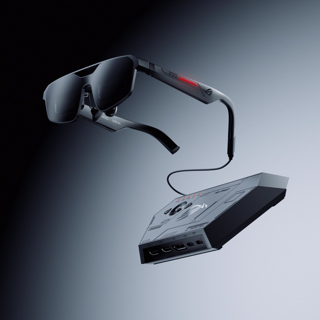 Stylish augmented reality glasses suspended above a sleek device with multiple ports and a connecting wire.