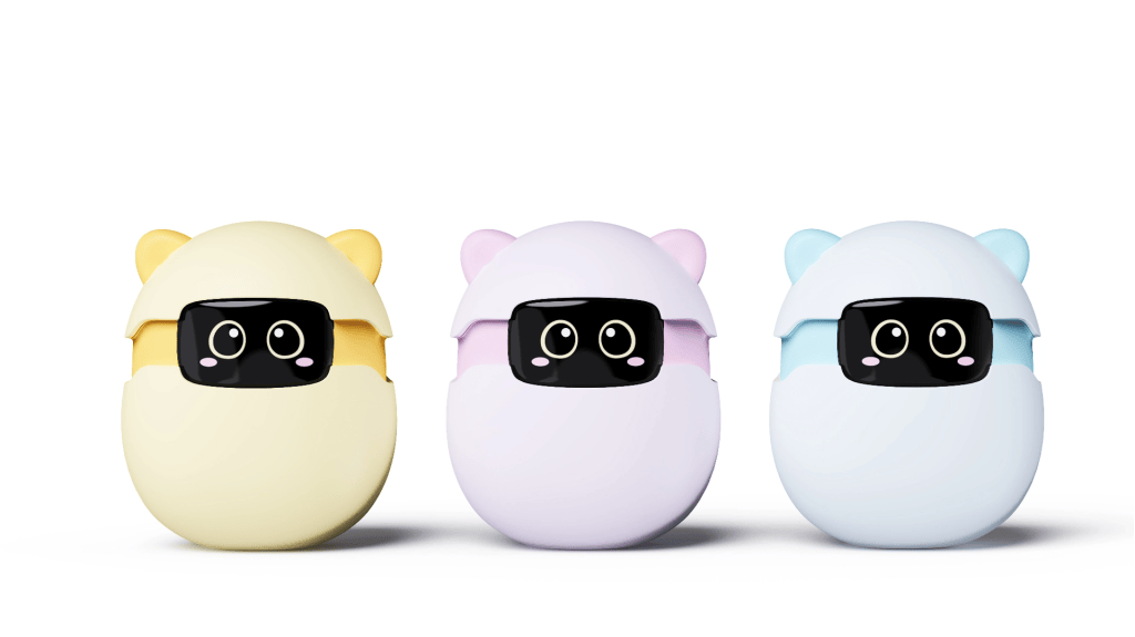 Three colorful cartoonish capsule toys with cat ears, featuring large expressive eyes. The colors include yellow, lavender, and light blue.