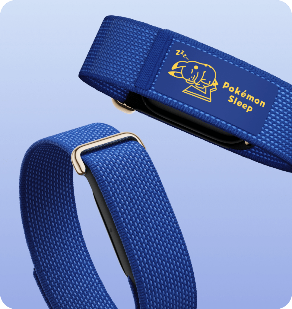 A blue fabric wristband with a Pokémon Sleep logo, featuring a cartoon elephant sleeping. The band is displayed on a gradient background.