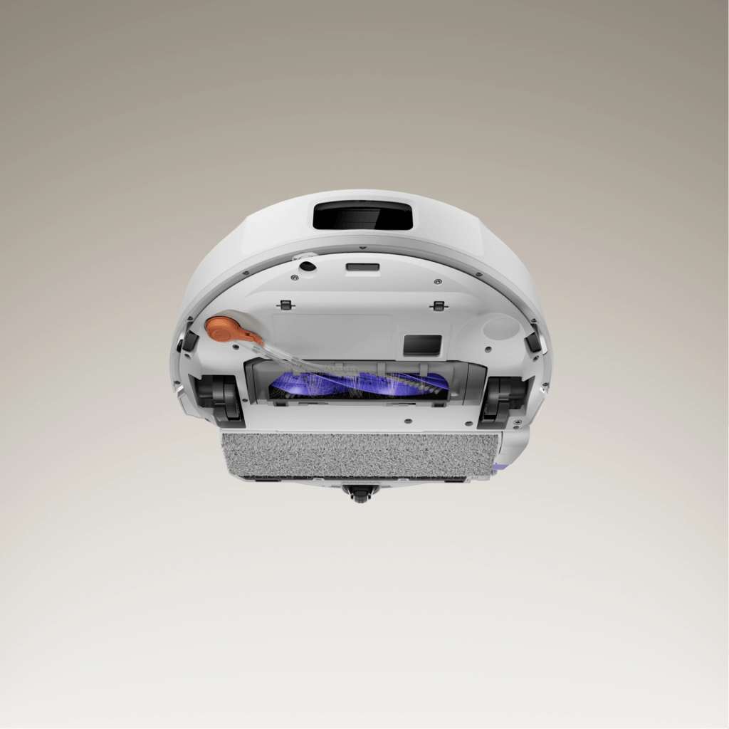 Close-up view of the underside of a robotic vacuum cleaner showing the internal components, including the brush, filtration system, and water tank.