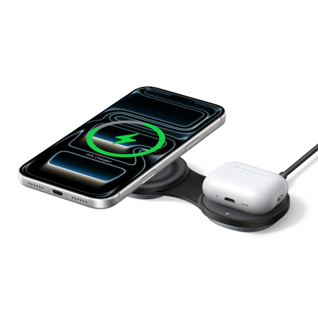A smartphone and wireless earbuds on a charging pad, displaying a charging status of 75% on the phone screen.