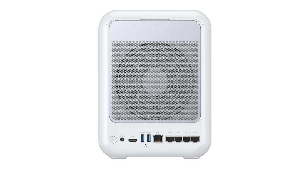 Back view of a compact white desktop computer with various ports including USB, HDMI, and Ethernet connections.
