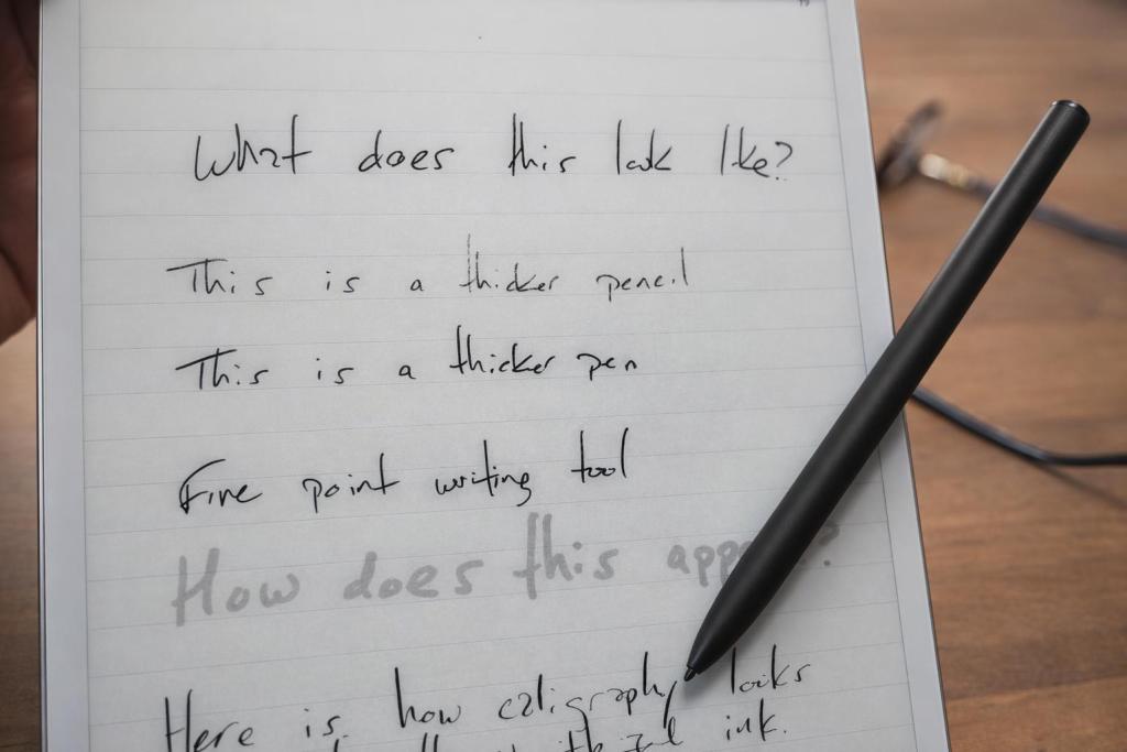 Close-up of a notepad with handwritten notes and a black pen resting on it, including comments about different writing tools.