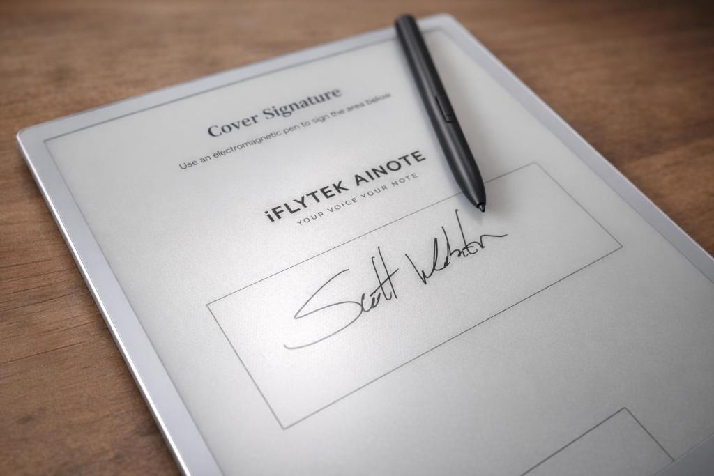 Digital signature being written on an electronic tablet with an electromagnetic pen, featuring the iFlytek AINOTE branding.