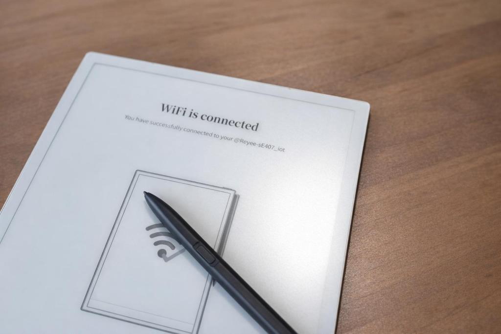 A digital display showing the message 'WiFi is connected' with a stylus placed nearby on a wooden surface.