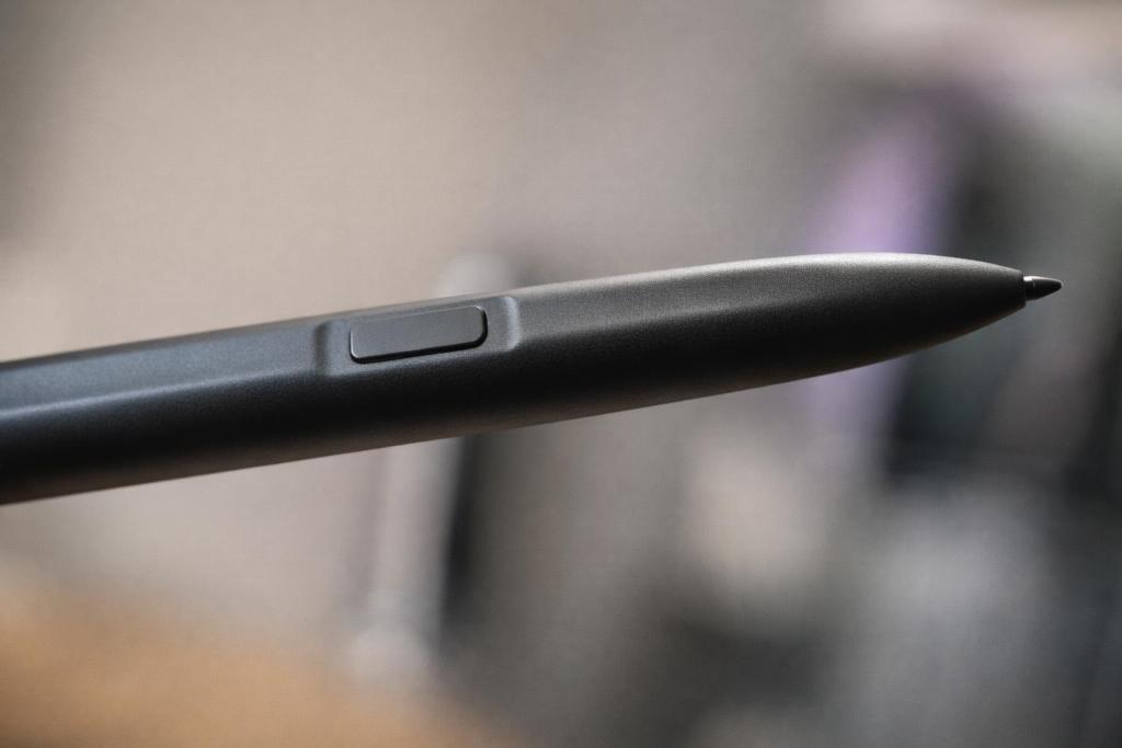 Close-up of a black stylus pen with a button on the side.