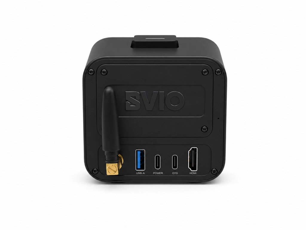 Back view of a compact black device featuring various ports including USB-A, power, OTG, and HDMI, with an antenna attached.
