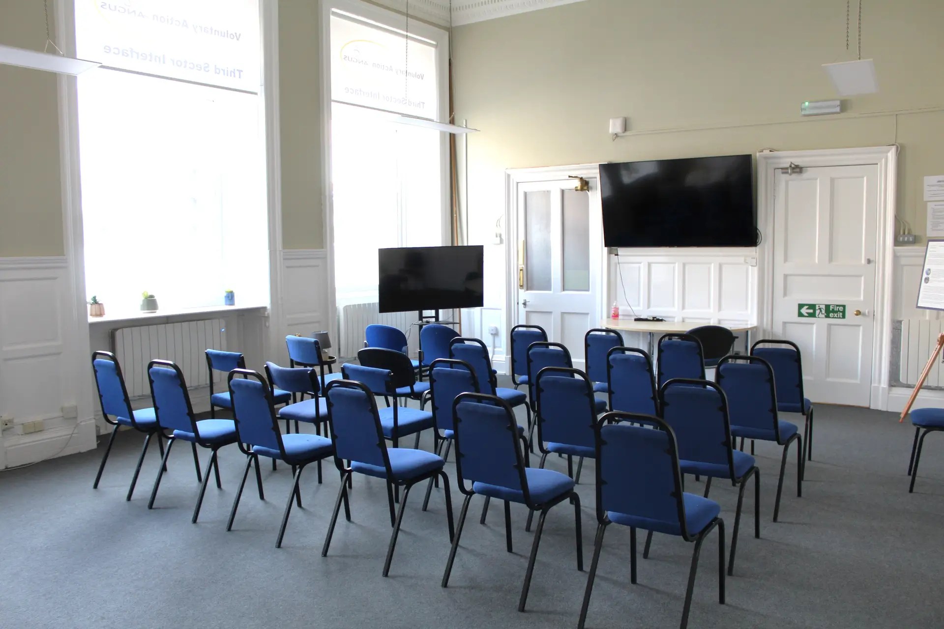 Meeting room setup with chairs and a presentation screen, in Angus
