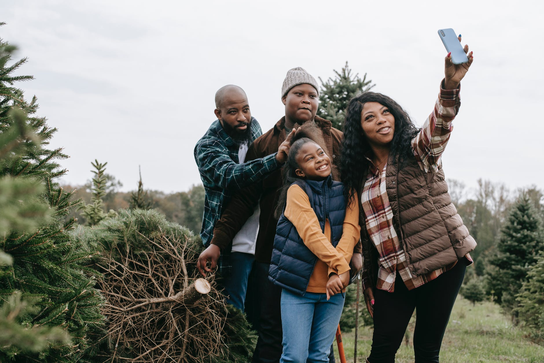 happy black family taking selfie on smartphone