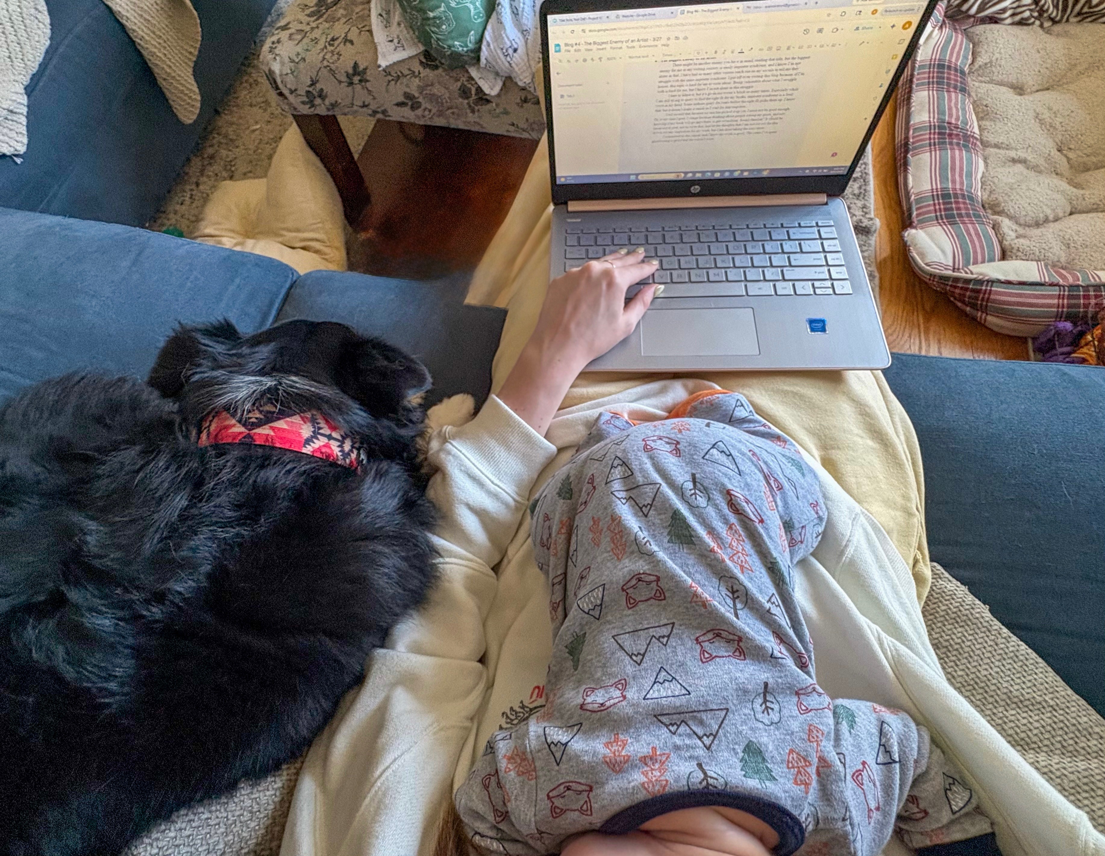 Author writing from home with baby and dog while balancing work and family life.