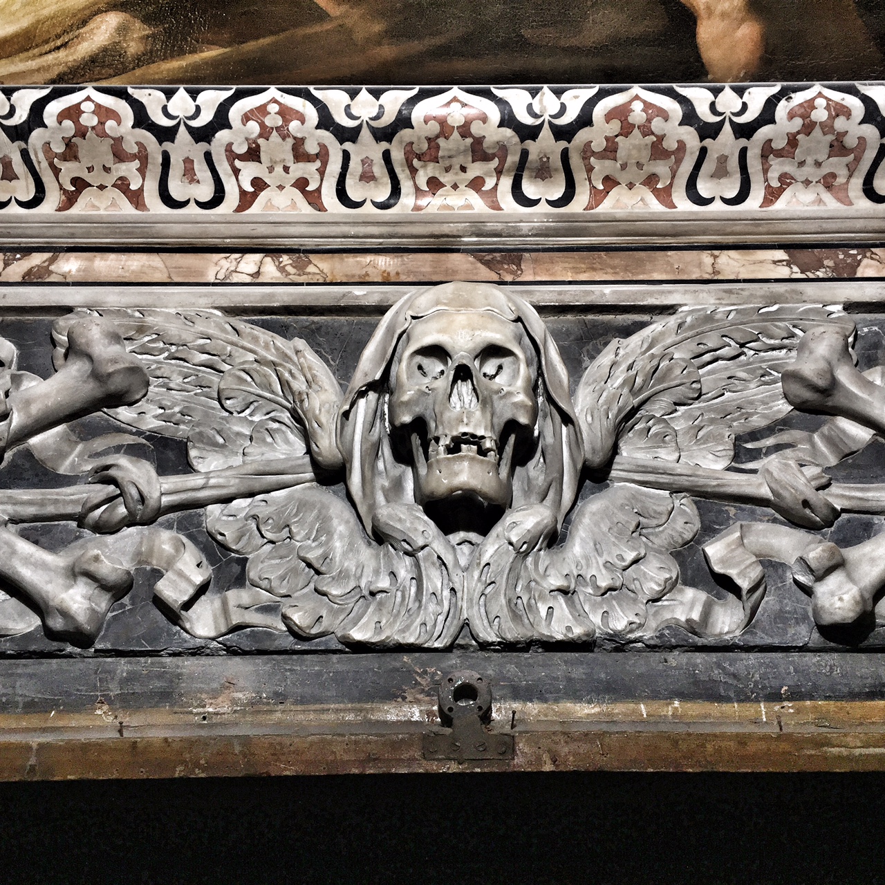 Chiesa di Santa Maria delle Anime del Purgatorio ad Arco. Dettaglio. Le 4 ossa ai lati del teschi rappresentano i 4 elementi, ovvero la fugacità della vita, i nodi sono le prove da superare, il cappuccio sono i peccati, e le ali rappresentano la salvezza (foto: Anna Luciani).