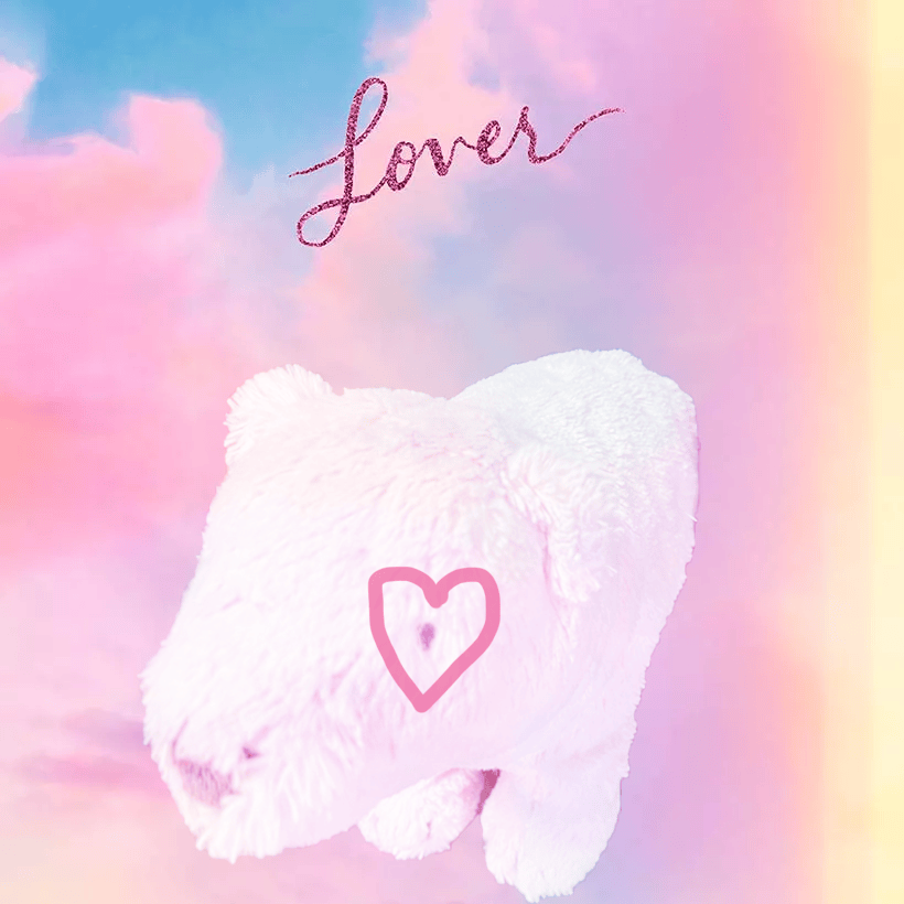 Pink polar bear stuffed animal with a glitter heart over the eye and the text "Lover" written in pink glitter cursive in the center