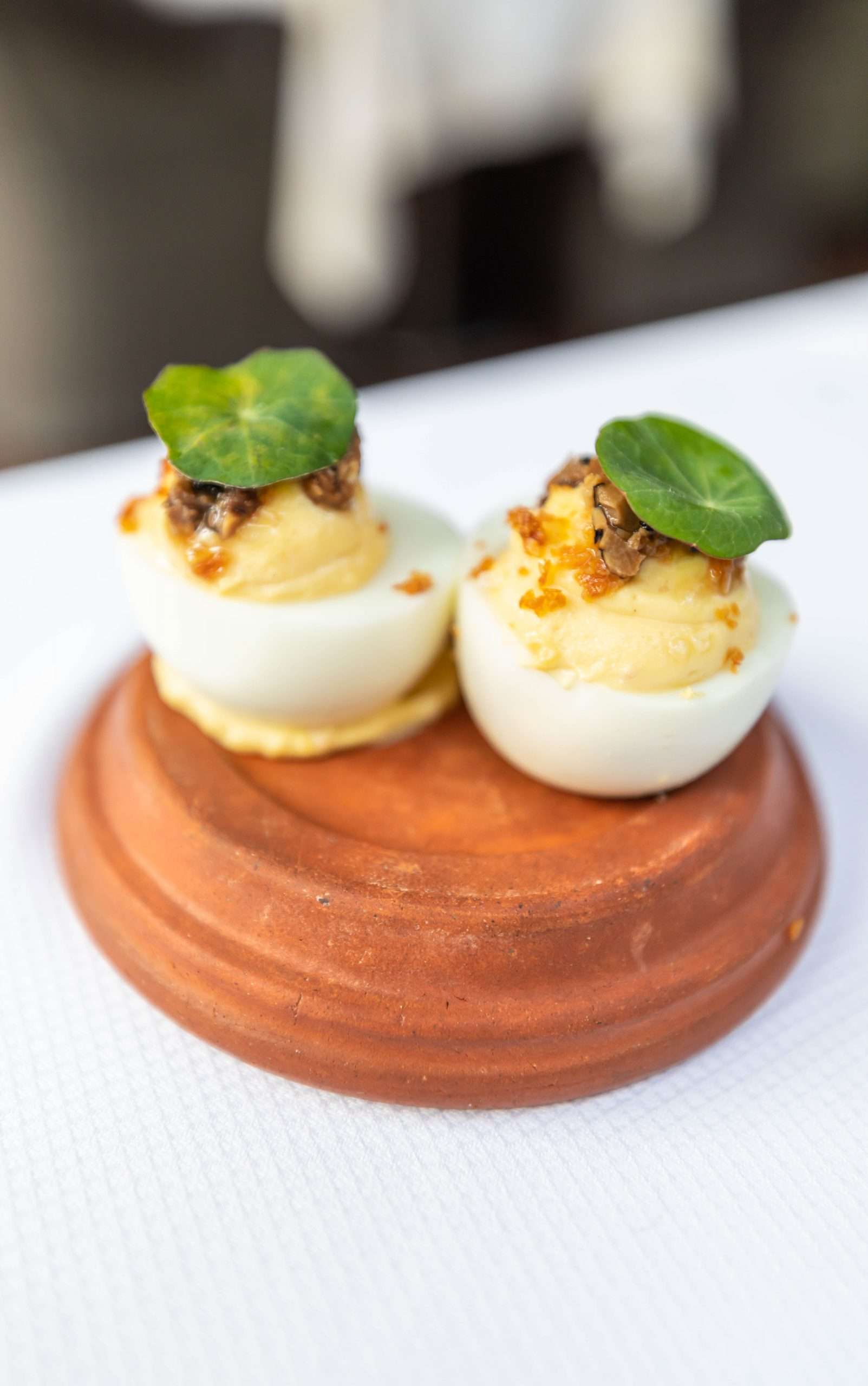 Deviled Eggs Appetizer Served on a Terra Cotta Lid at Zero George Restaurant + Bar in Charleston South Carolina Photographed and Written By Annie Fairfax Meal Prepared by Chef Vinson Petrillo