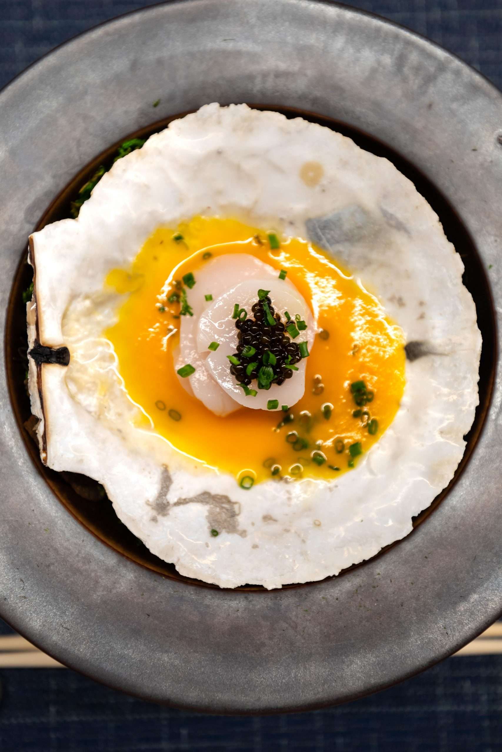 Hotate (Sea Scallop) with beluga caviar served on a scallop shell at Kissaki Greenwich Connecticut Photographed by Annie Fairfax