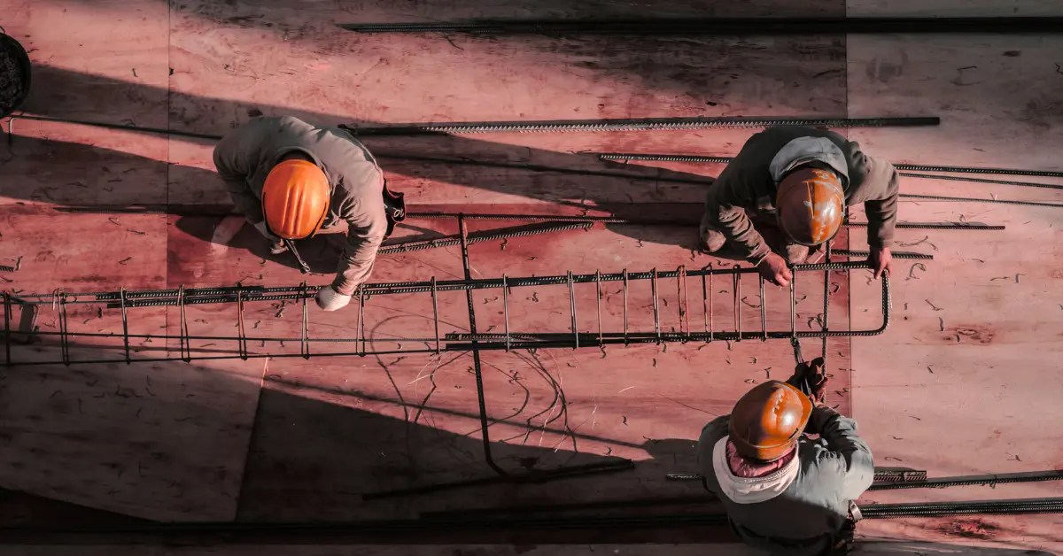 Construction Workers on Site - Professional Team with Orange Hard Hats Overseeing Construction Project