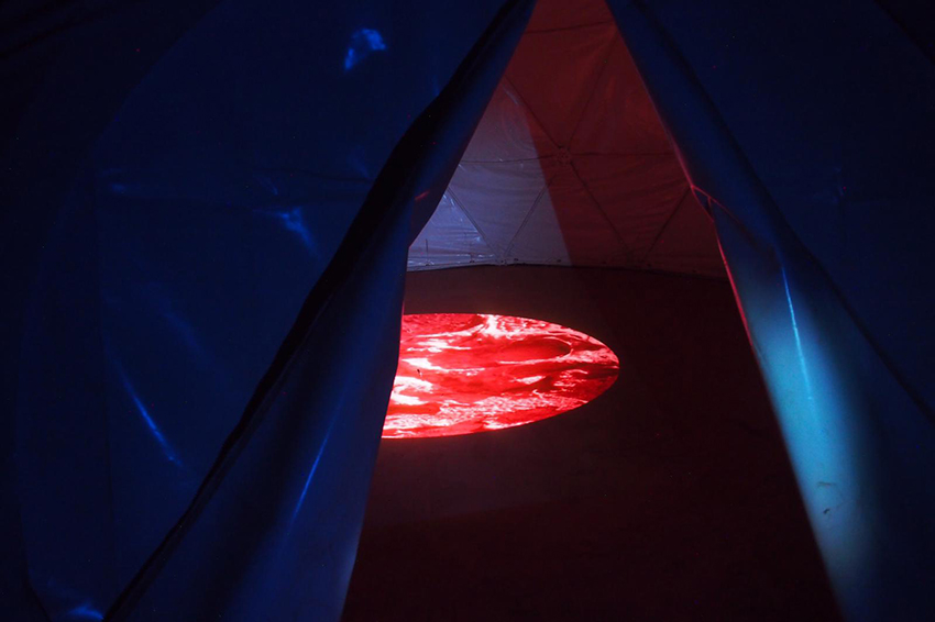 Projection of A Baker's Dozen: A Lunar Study in Variations of Size and Shape' onto the bare ground at The Earth Sanctuary, central Australia. Copyright Anna Dakin