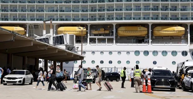 Passengers and vehicles at a cruise terminal drop-off