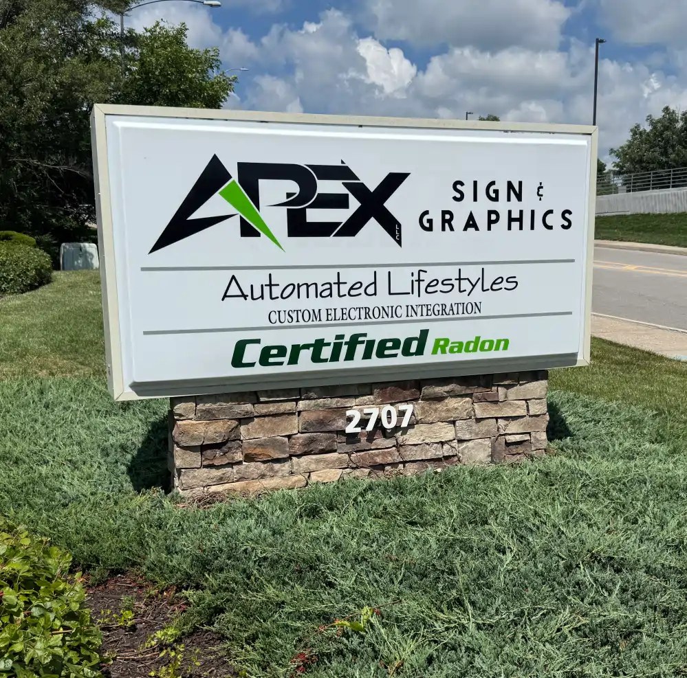 Multi-tenant internally illuminated monument sign displaying multiple business names with LED lighting