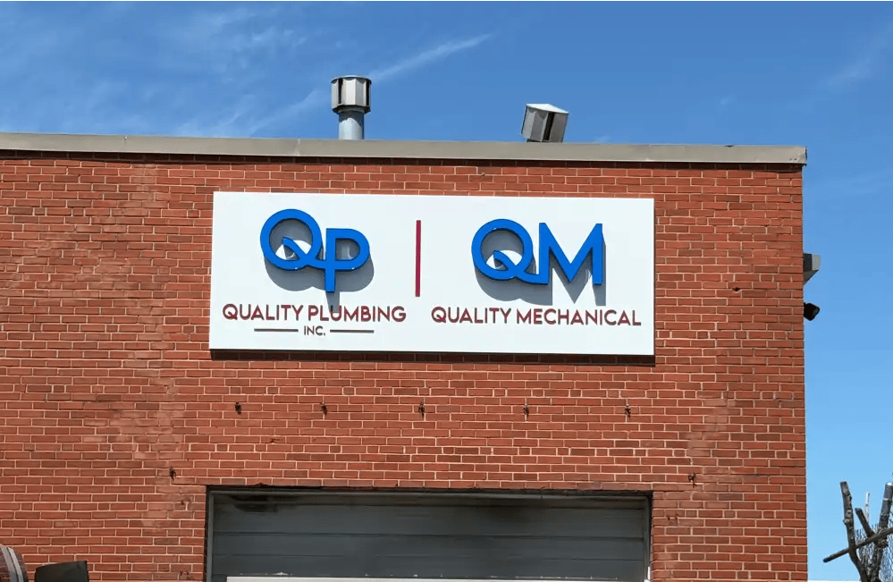 Quality Plumbing pan sign with illuminated channel LED letters and flat cutout aluminum letters on building exterior