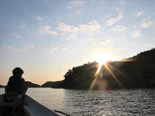 Image of a boy watching the sun rise in the Philippines