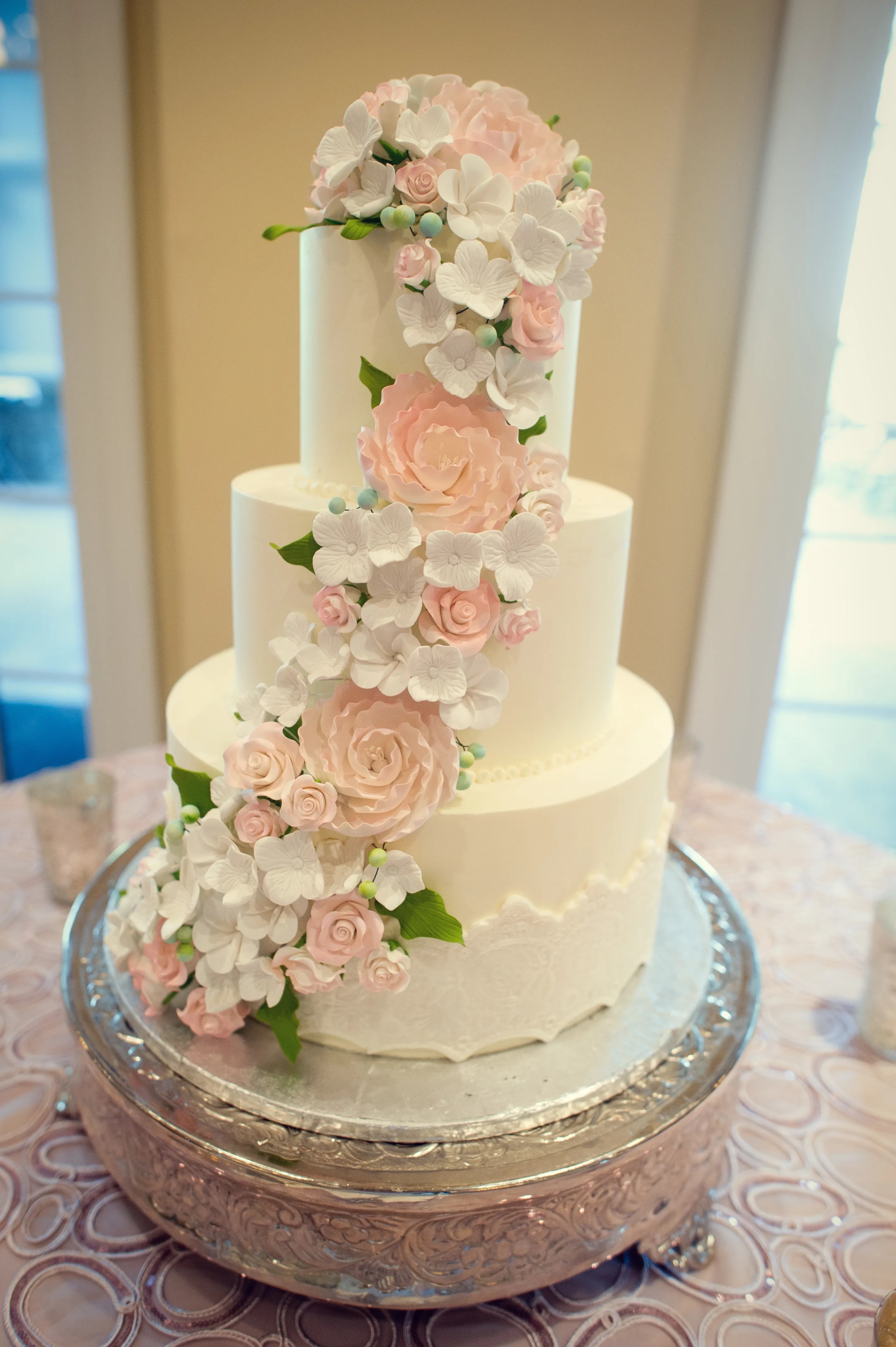 These guest book alternatives are perfect for a variety of unique wedding themes. Three-Tier Wedding Cake with Cascading Fondant Flowers