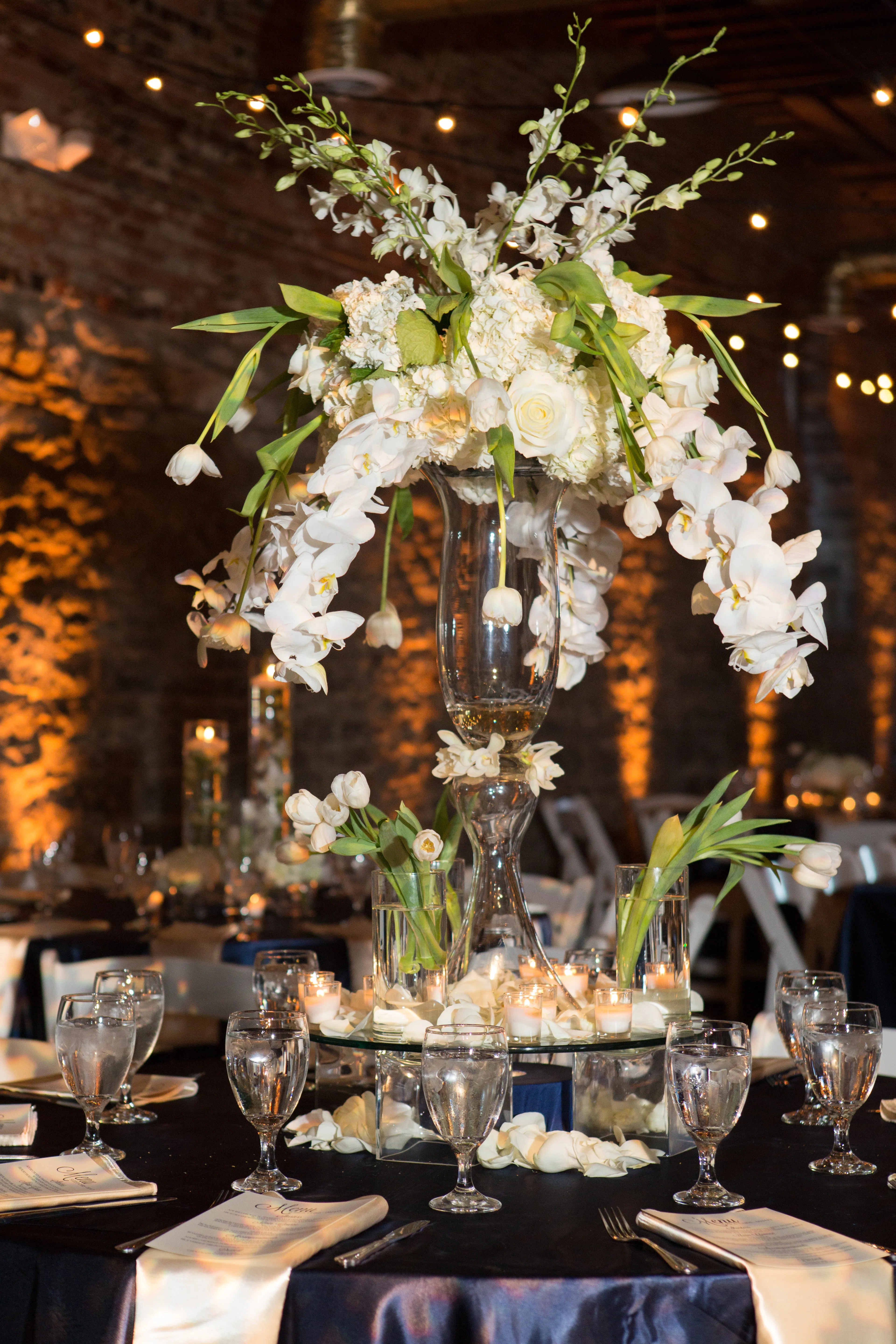 Planning your nuptials for the cold weather season presents unique opportunities: Modern White Orchid Cascade Centerpieces