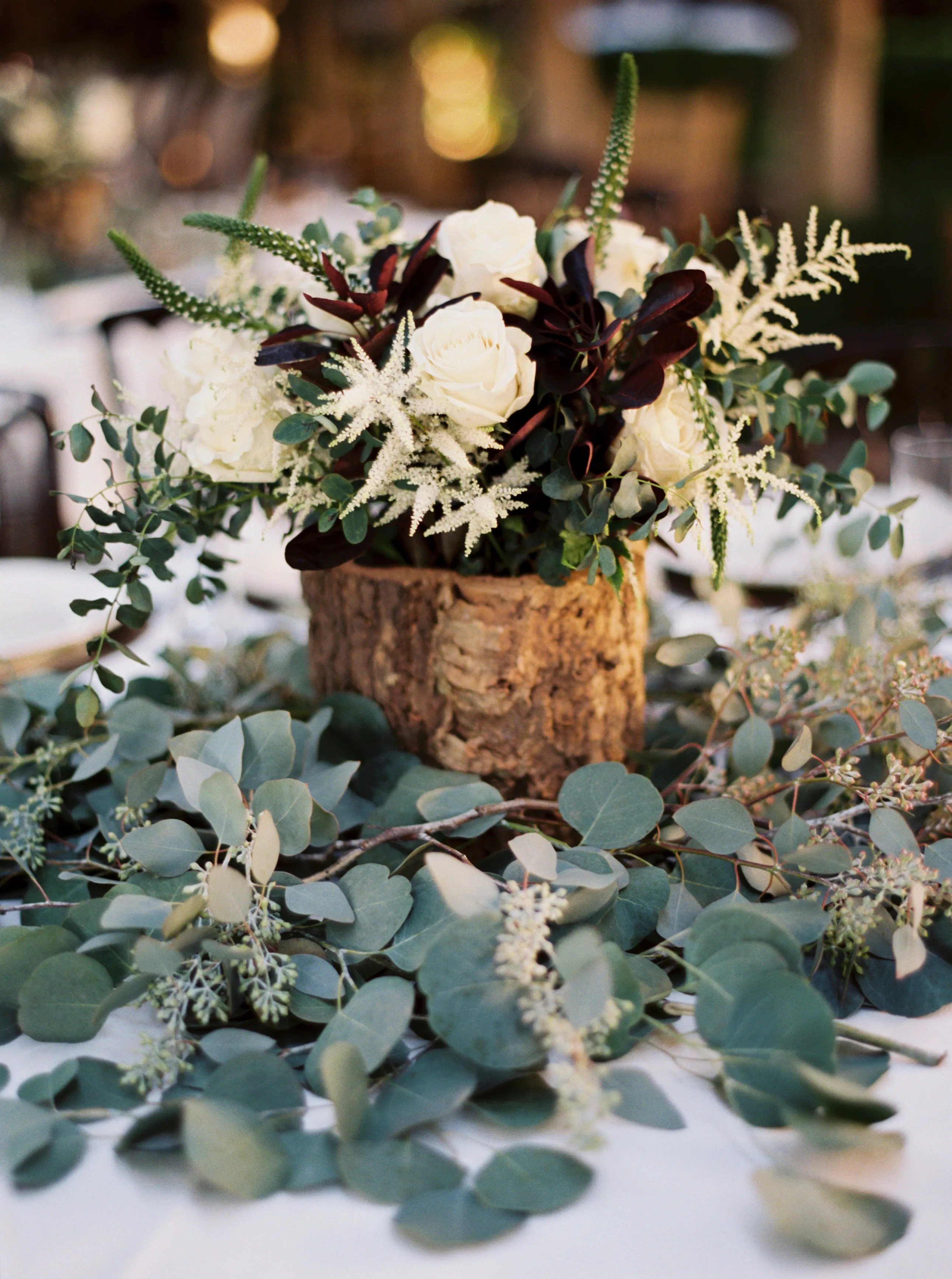 42+ New Cheap Wedding Rehearsal Dinner Ideas : Rustic Wooden Centerpiece on Eucalyptus Leaves : To keep things simple and inexpensive, try a mexican or italian food night with things such as spaghetti and garlic bread or tacos on the menu.