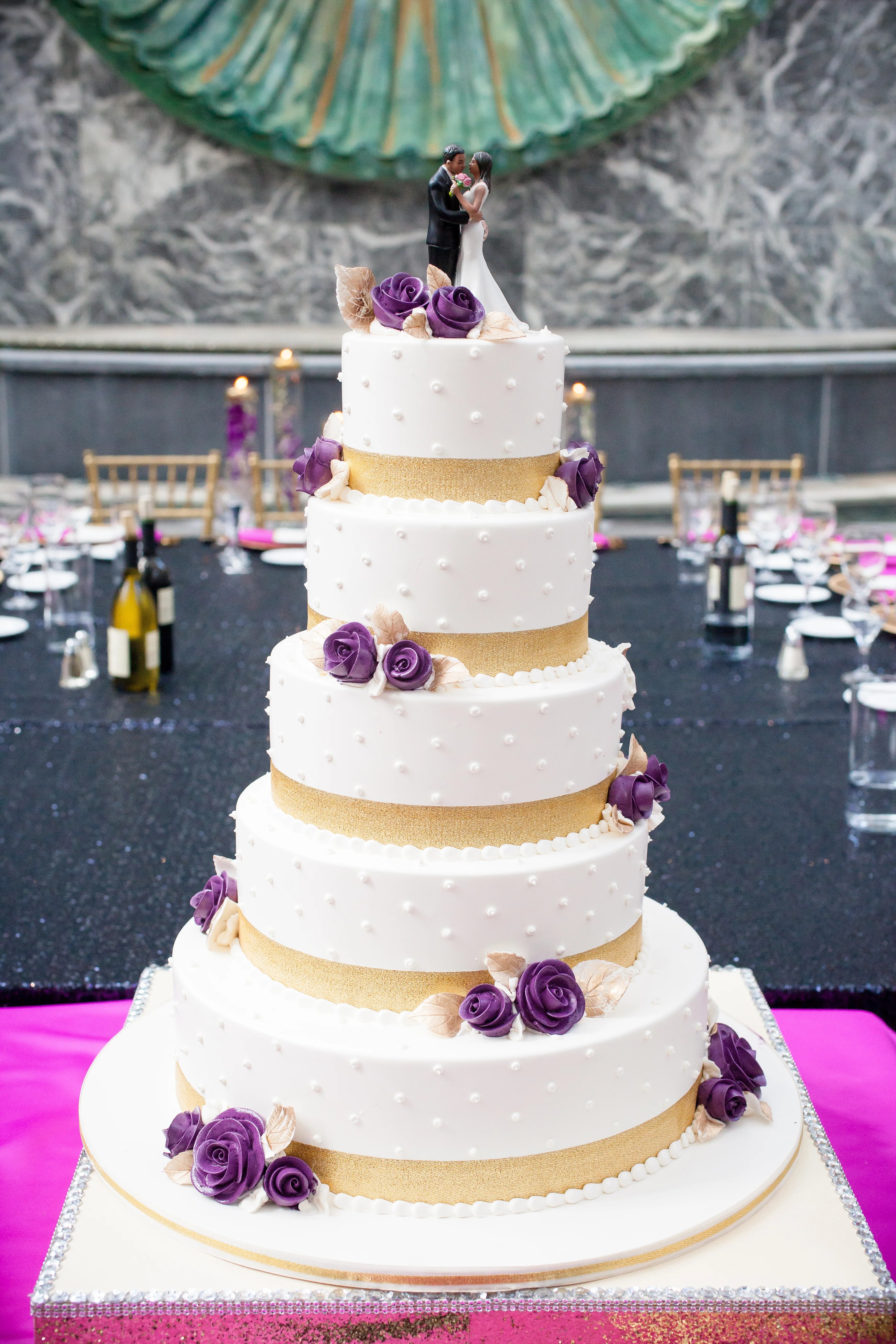 We may earn commission on some of the items you choose to buy. Five-Tier White, Gold and Purple Wedding Cake