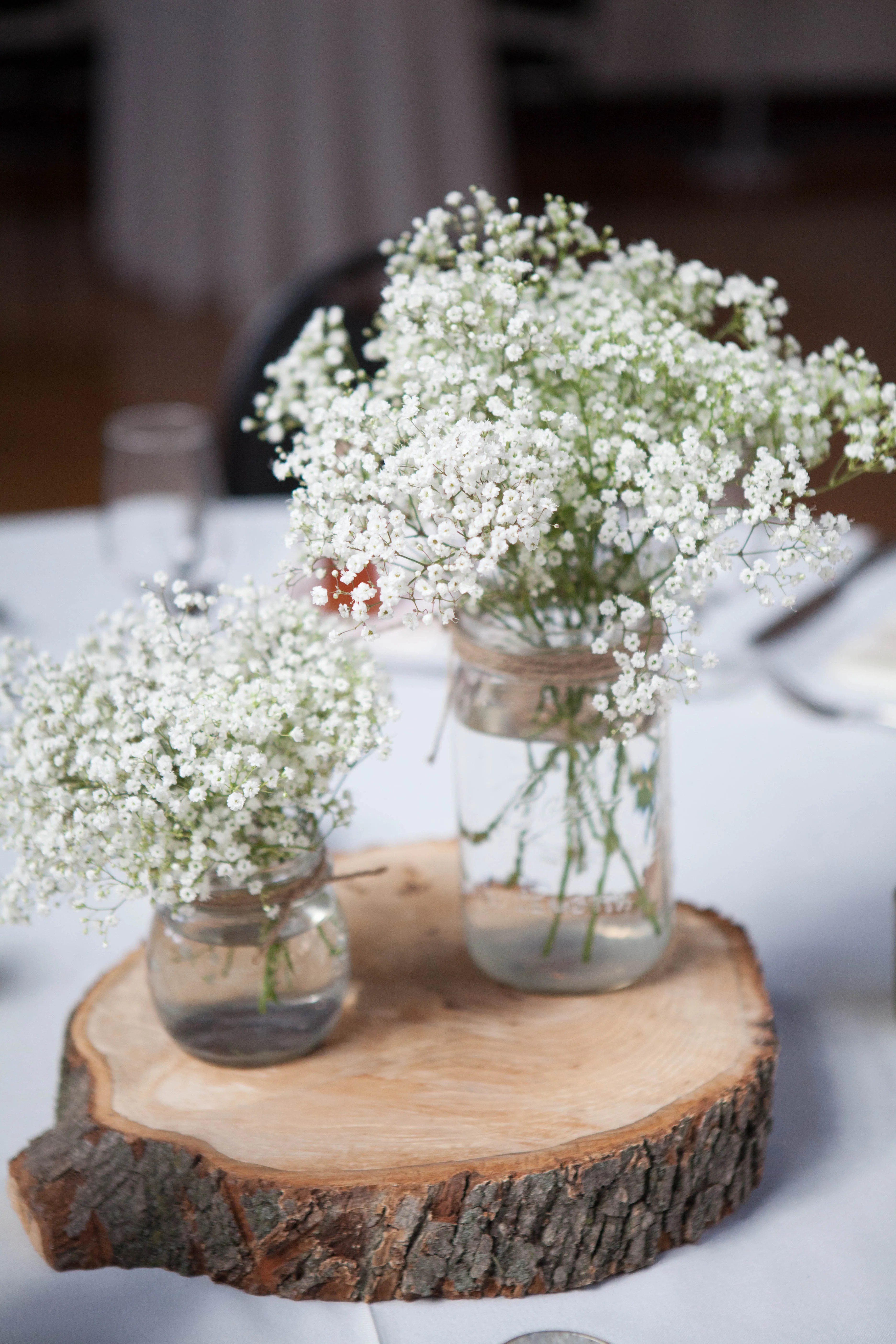 Wood wedding bands made from whiskey barrels and historic woods. Rustic Mason Jar, Babyâ€™s Breath and Wood Centerpieces