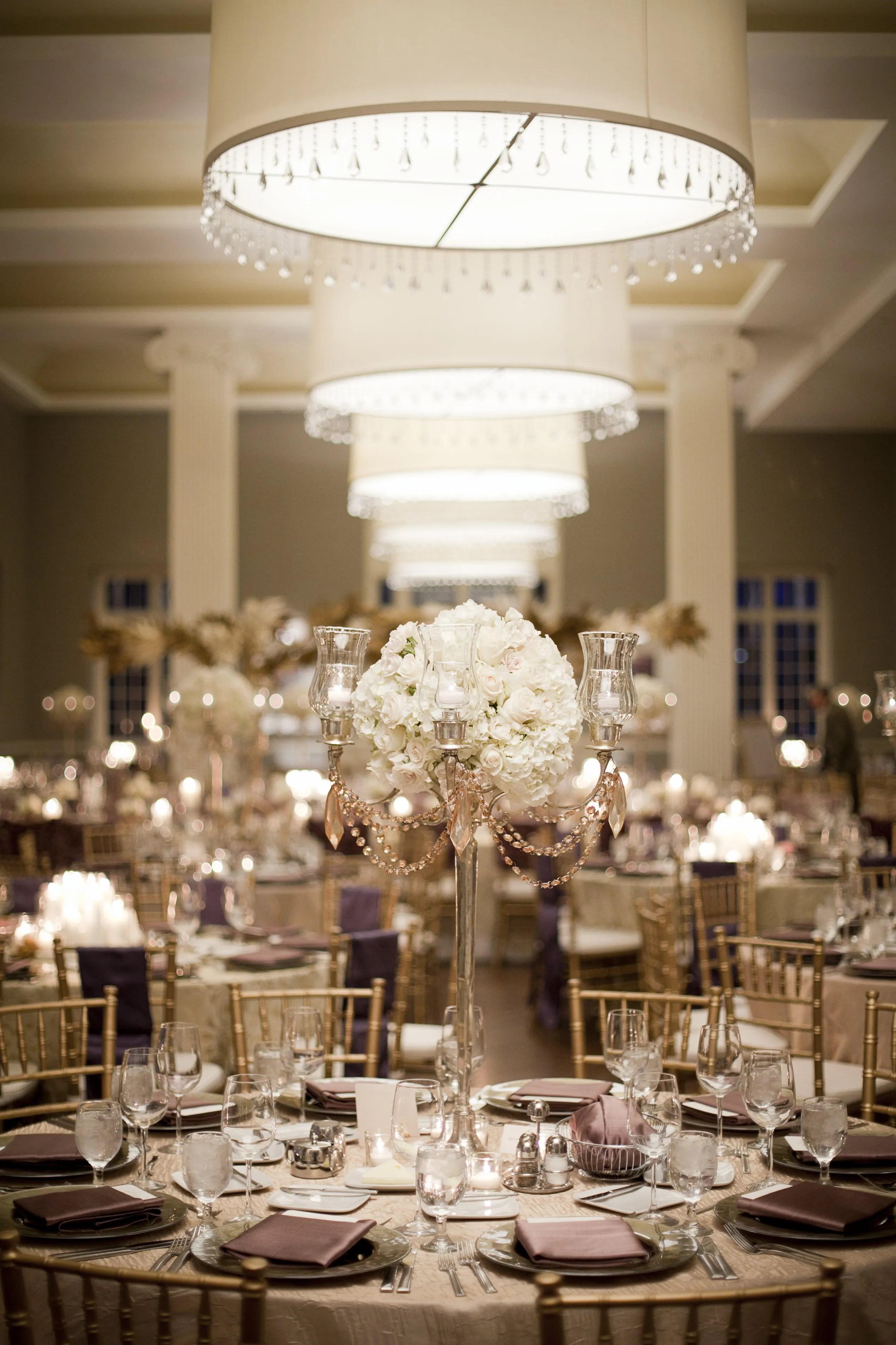 In the glitzy 1980s, lavish receptions became de rigueur; Gold Candelabra and Ivory Rose Centerpieces